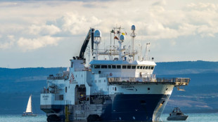 Migrants come ashore at Italian port as another ship heads to France