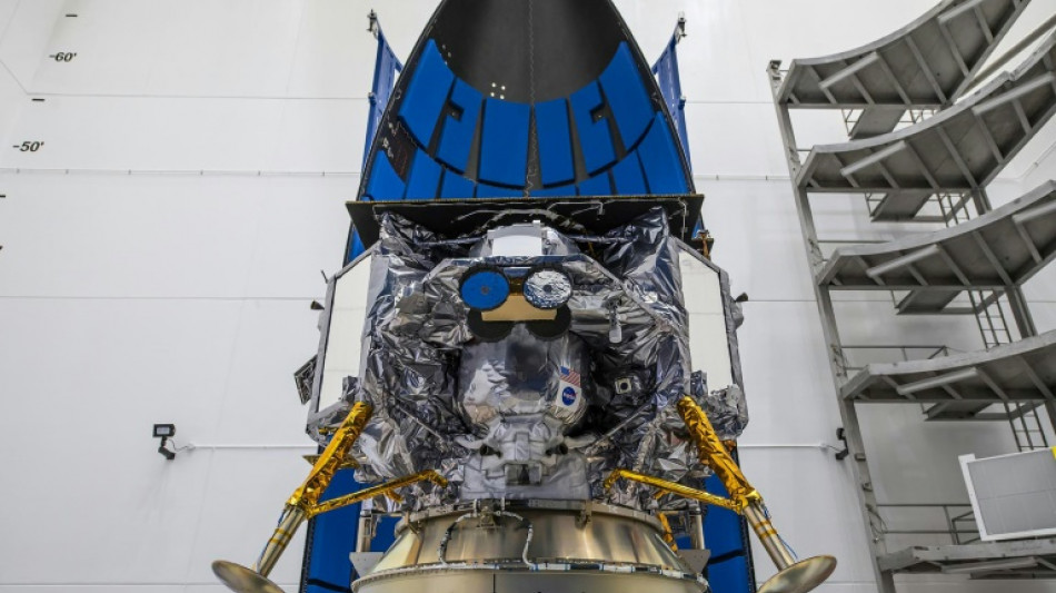 Rocket carrying American lunar lander rolls to launchpad