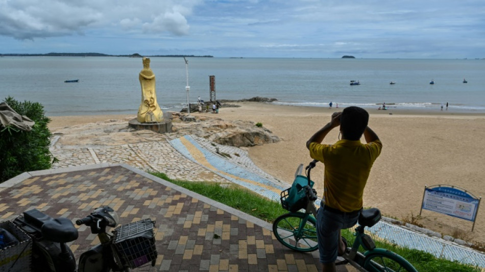 A stone's throw from Taiwan, beachgoers aren't worried about war