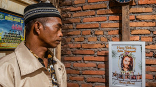 At Indonesia cemetery, father kisses daughter killed in stadium crush goodbye