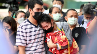 Distraught parents lay white roses for Thai nursery massacre victims