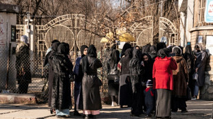 Armed guards stop Afghan women entering universities after Taliban ban