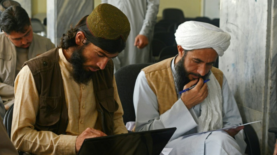 Taliban fighters swap arms for books as hundreds return to school